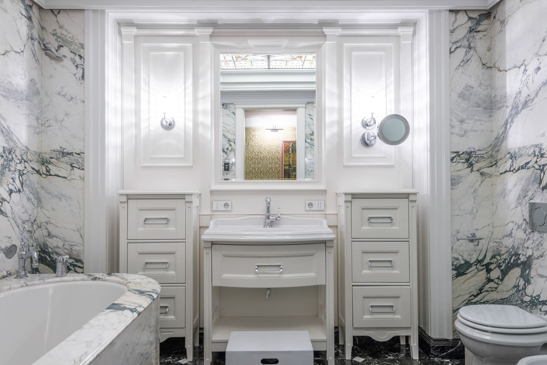 Elegant bathroom design featuring marble walls and modern fixtures.